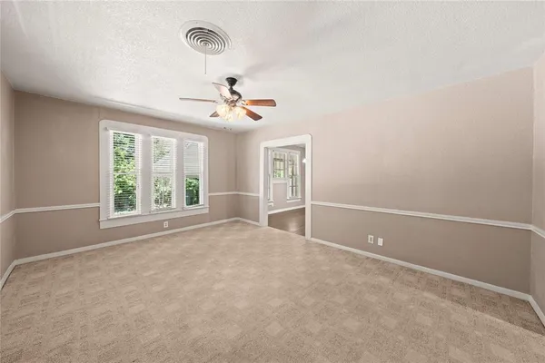 a view of room with window and ceiling fan