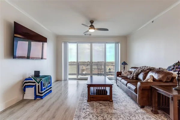 a living room with furniture and a floor to ceiling window