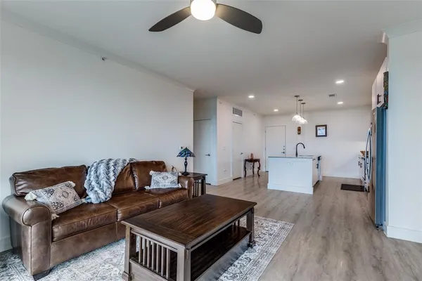 a living room with furniture and a wooden floor