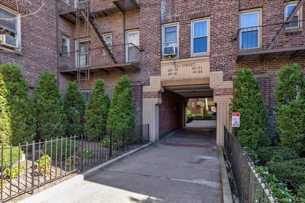 a view of a house with brick walls