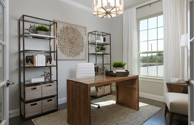 a view of a workspace with furniture and a window