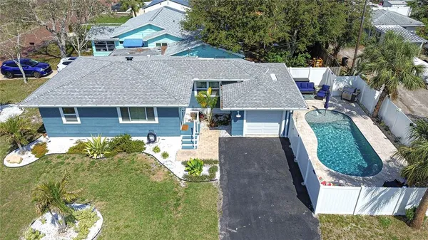 an aerial view of a house with swimming pool and glass windows