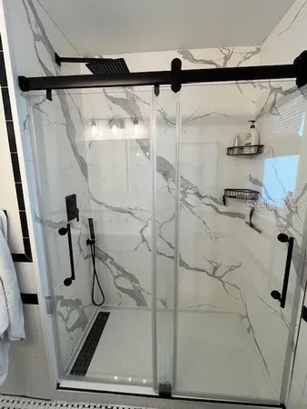 a bathroom with a shower and a sink