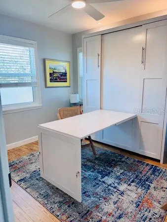 a view of a workspace room with wooden floor