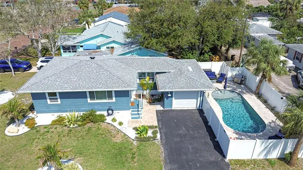 an aerial view of a house with a yard