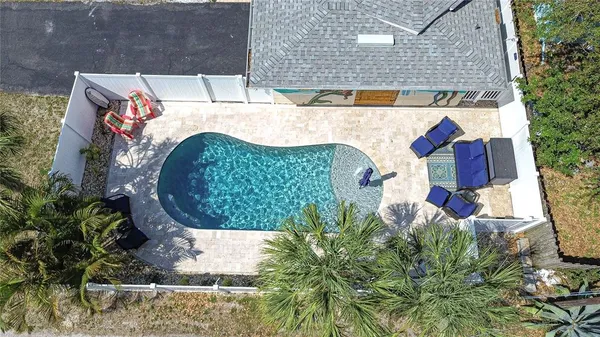 an aerial view of a house with a yard and plants