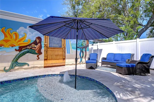 a view of patio with a table and chairs under an umbrella
