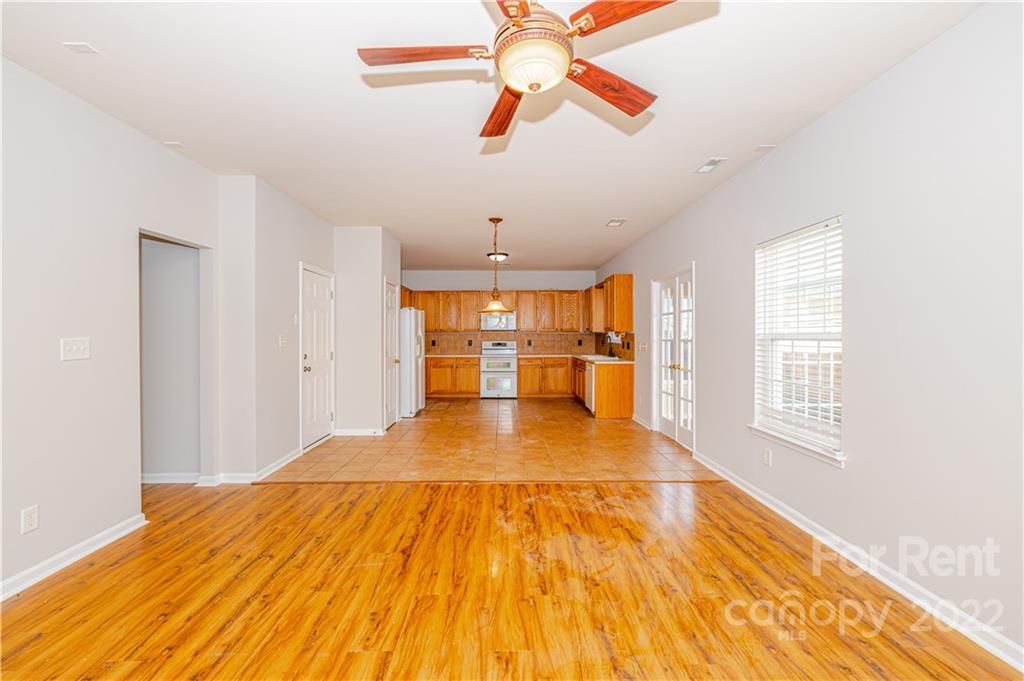 3329 Burnage Hall Road Harrisburg, NC 28075 - Photo 14 of 47 a view of empty room with wooden floor and fan