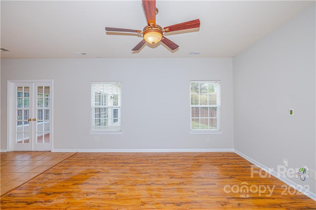 3329 Burnage Hall Road Harrisburg, NC 28075 - Photo 15 of 47 a view of an empty room with window and wooden floor