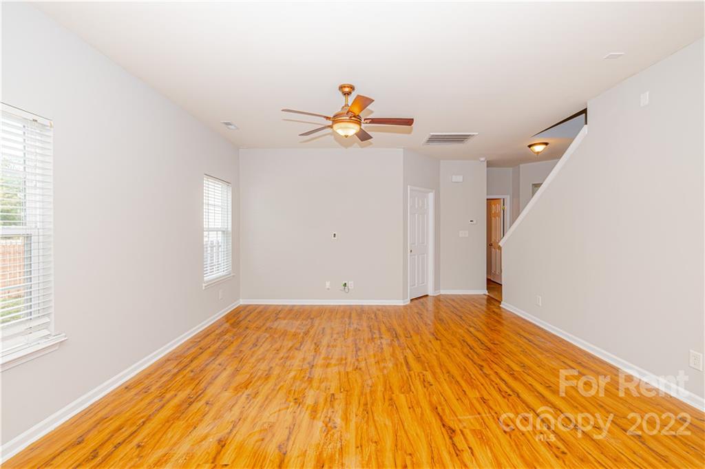 3329 Burnage Hall Road Harrisburg, NC 28075 - Photo 20 of 47 a view of empty room with wooden floor and fan