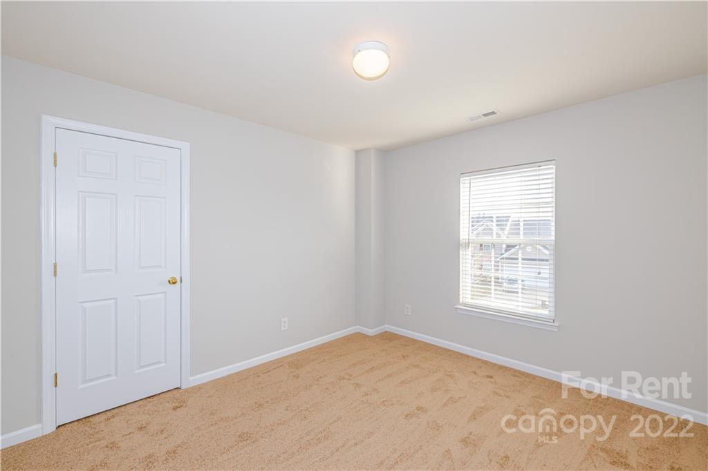 3329 Burnage Hall Road Harrisburg, NC 28075 - Photo 21 of 47 an empty room with windows
