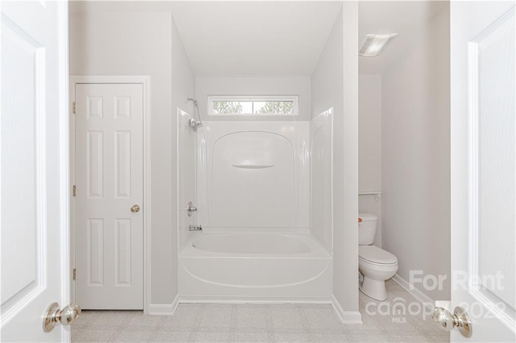 3329 Burnage Hall Road Harrisburg, NC 28075 - Photo 27 of 47 a bathroom with a granite countertop toilet and a shower
