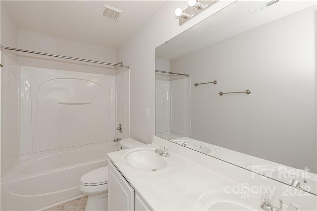 3329 Burnage Hall Road Harrisburg, NC 28075 - Photo 33 of 47 a bathroom with a sink toilet and shower