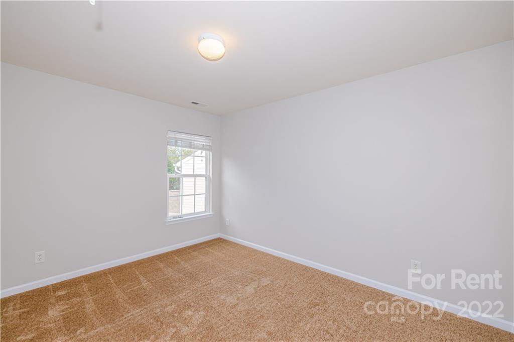 3329 Burnage Hall Road Harrisburg, NC 28075 - Photo 34 of 47 an empty room with windows