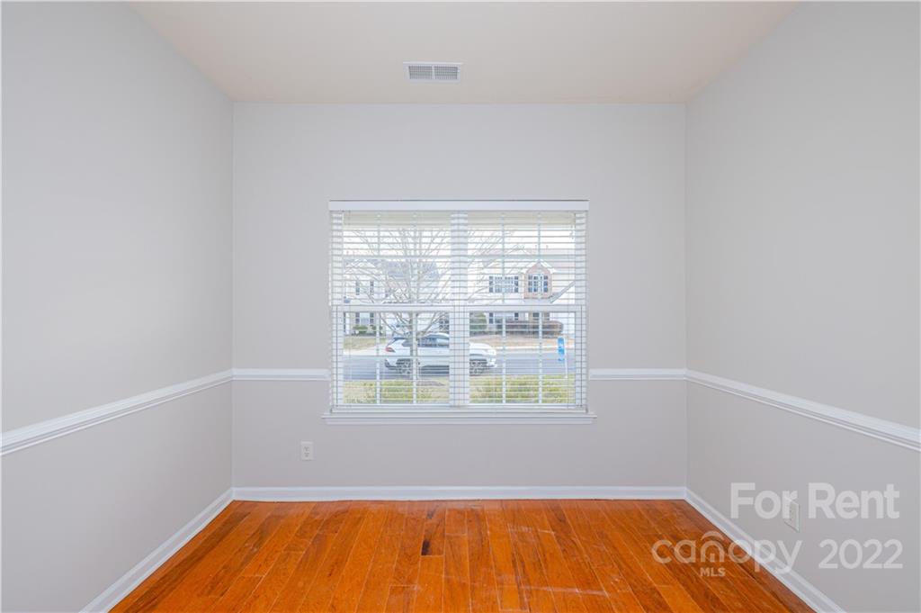 3329 Burnage Hall Road Harrisburg, NC 28075 - Photo 7 of 47 a view of a room with wooden floor and a window