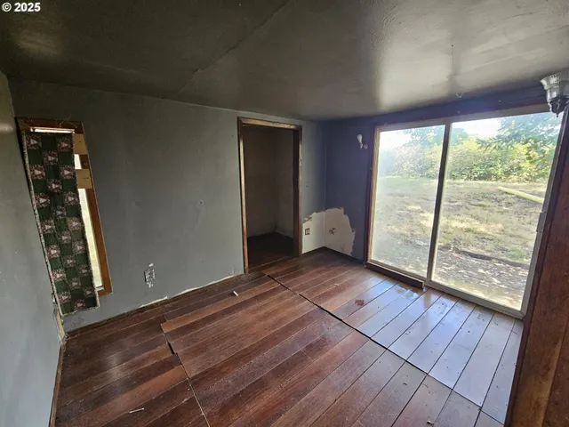 a view of wooden floor and windows in a room