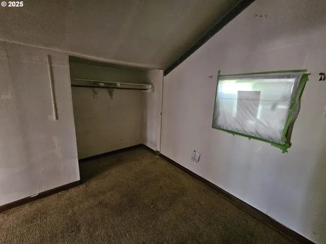 a view of a small space with wooden floor and a window