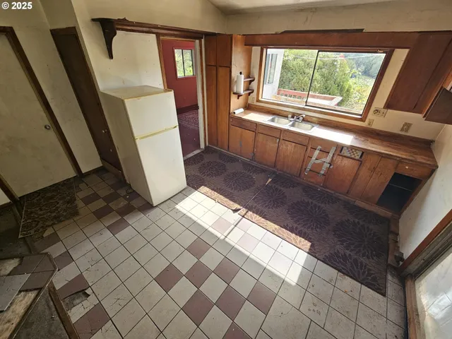 a kitchen with a refrigerator a sink and a stove