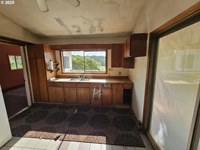 a bathroom with a glass shower door and a sink