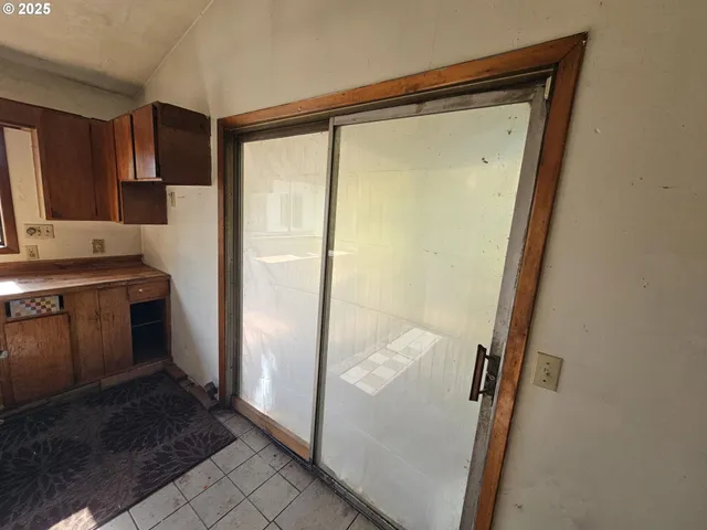 a view of a hallway with wooden floor and entryway