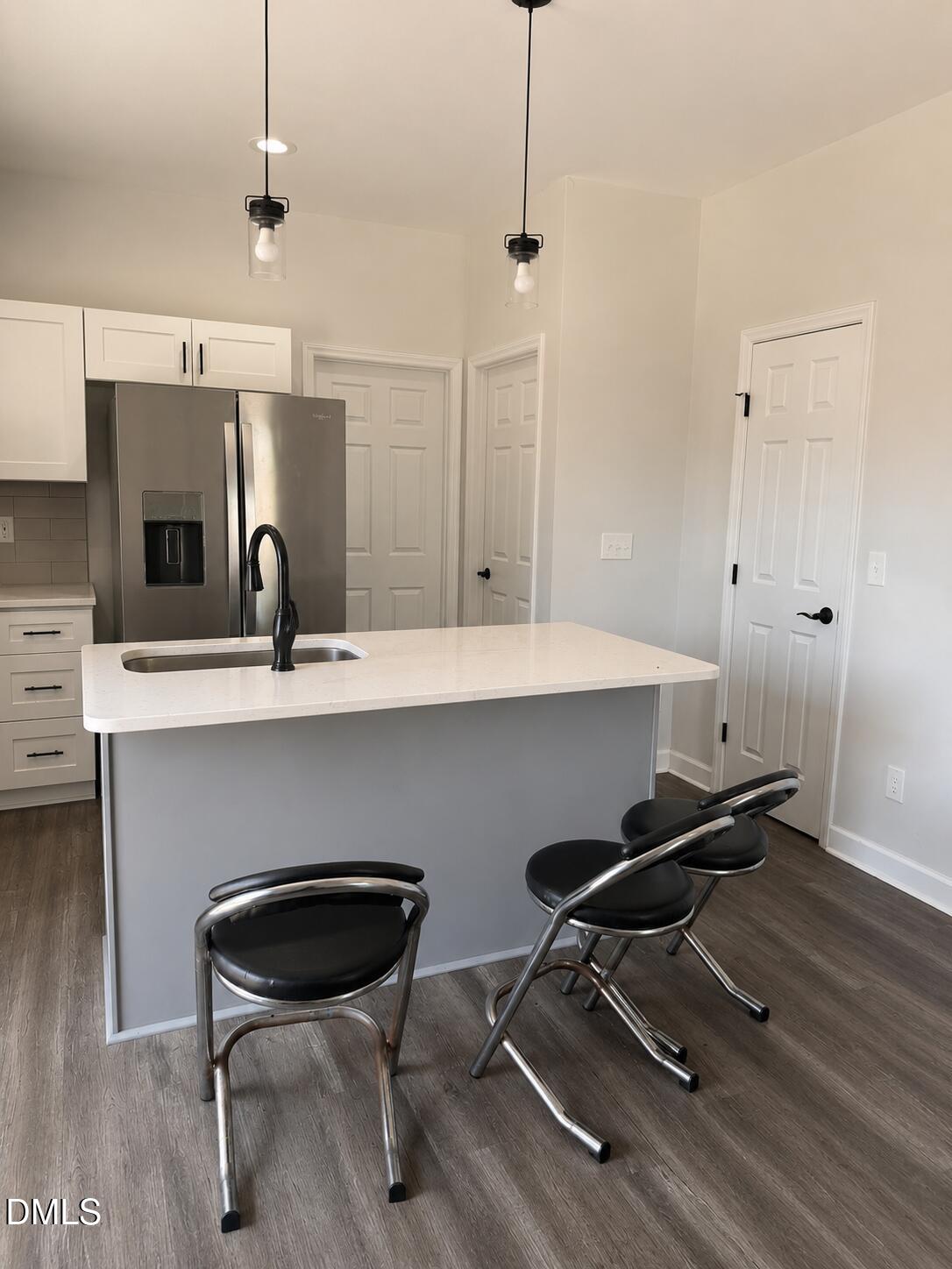 1003 Alma Street, Unit B Durham, NC 27703 - Photo 3 of 5 a kitchen with a sink a counter space and appliances