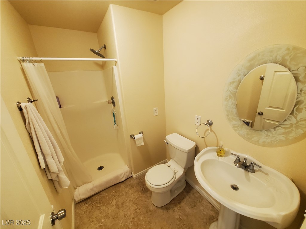 5272 Truman Lane Caliente, NV 89008 - Photo 5 of 39 Full bathroom featuring a sink, toilet, and a shower with curtain