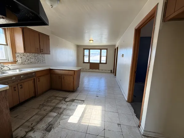 a view of a kitchen with sink and window