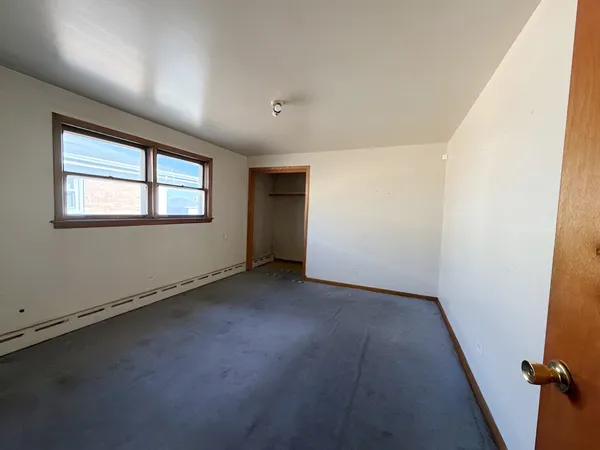 an empty room with a empty space and windows