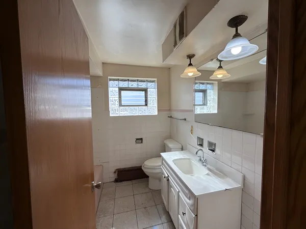 a bathroom with a sink toilet and a mirror