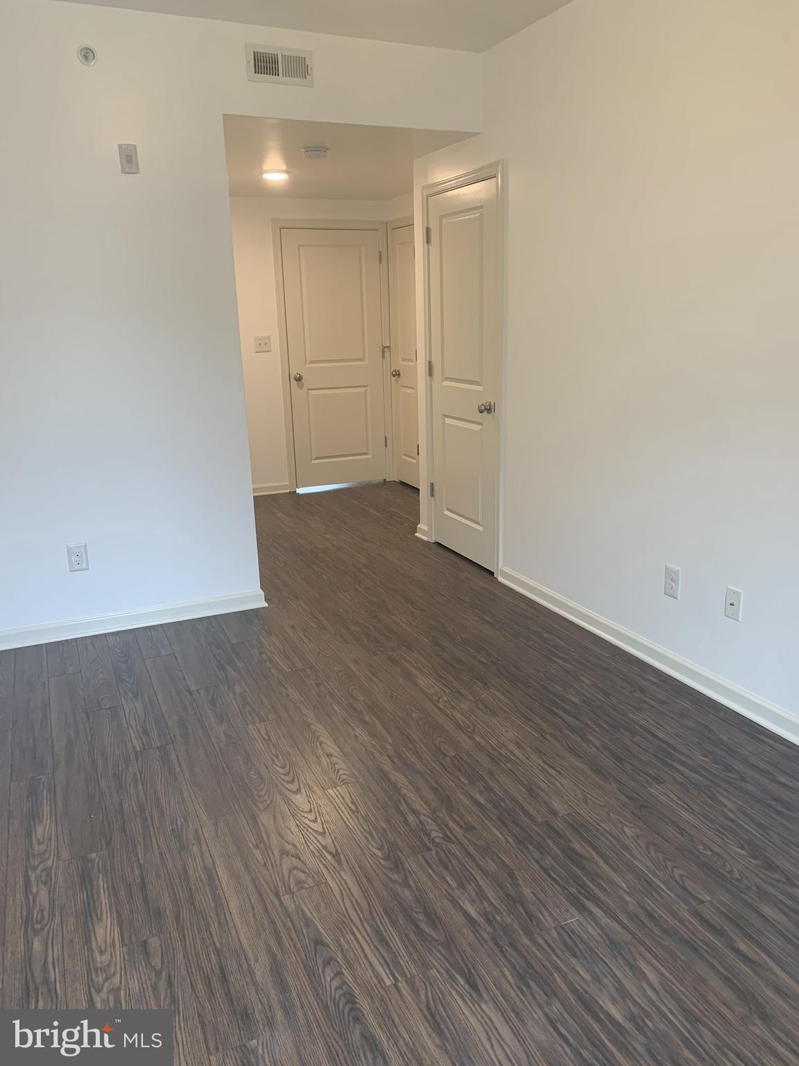 6619 Ridge Avenue, Unit 406 Philadelphia, PA 19128 - Photo 11 of 18 an empty room with wooden floor