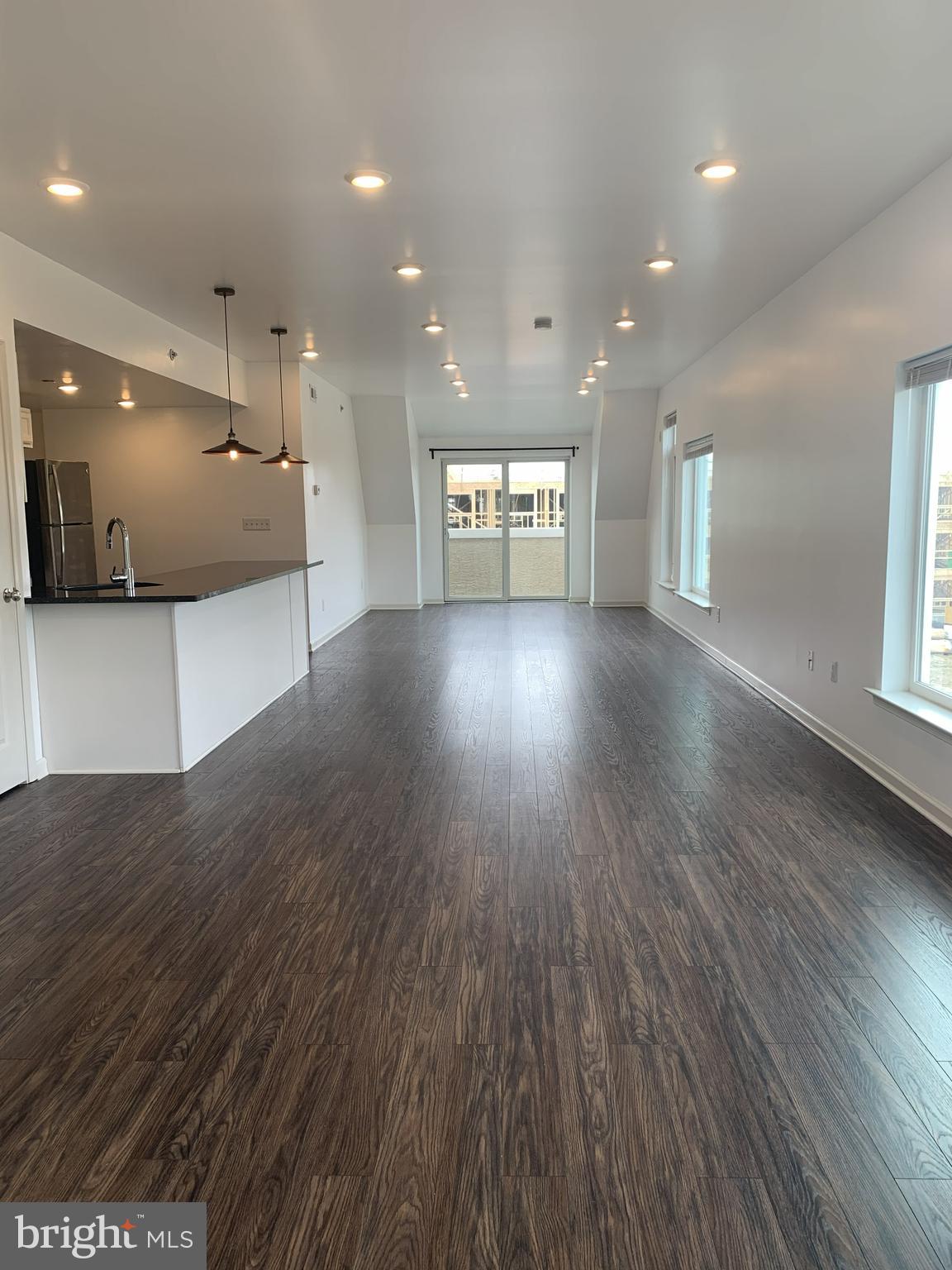 6619 Ridge Avenue, Unit 406 Philadelphia, PA 19128 - Photo 4 of 18 a view of an empty room with window and wooden floor
