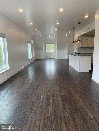a view of kitchen with cabinets and wooden floor