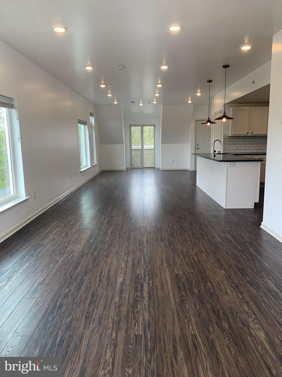 6619 Ridge Avenue, Unit 406 Philadelphia, PA 19128 - Photo 5 of 18 a view of kitchen with cabinets and wooden floor