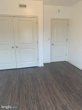 an empty room with wooden floor