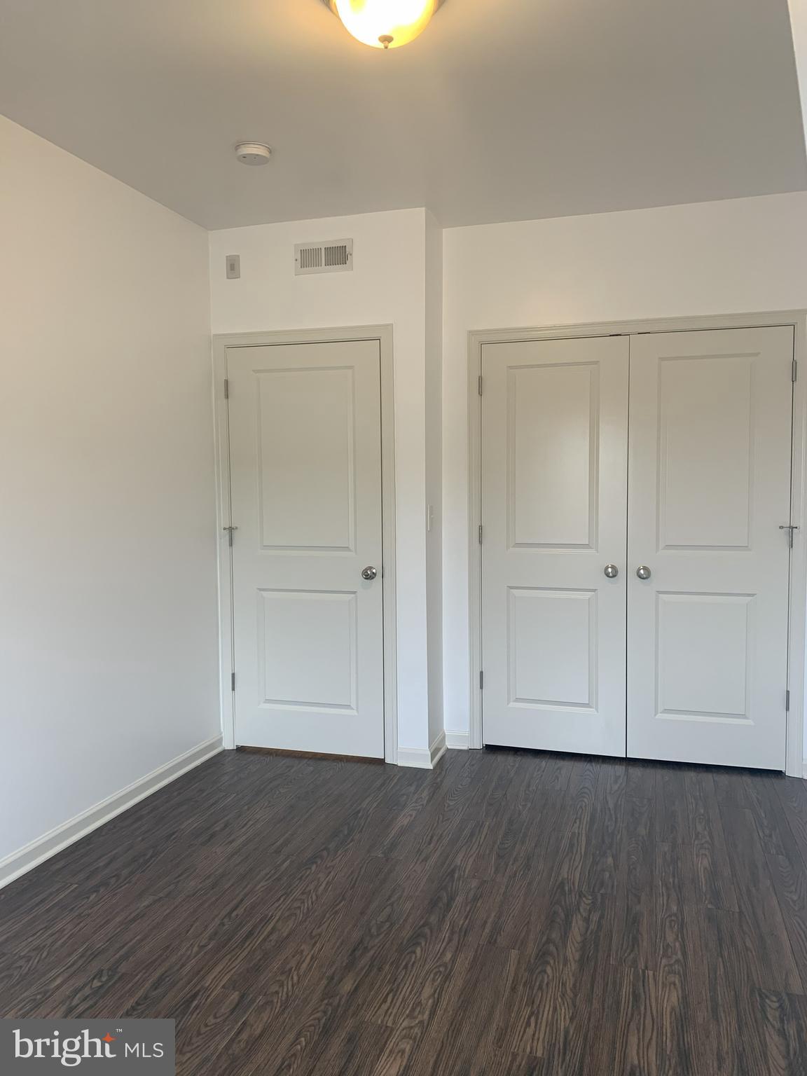 6619 Ridge Avenue, Unit 406 Philadelphia, PA 19128 - Photo 8 of 18 an empty room with wooden floor