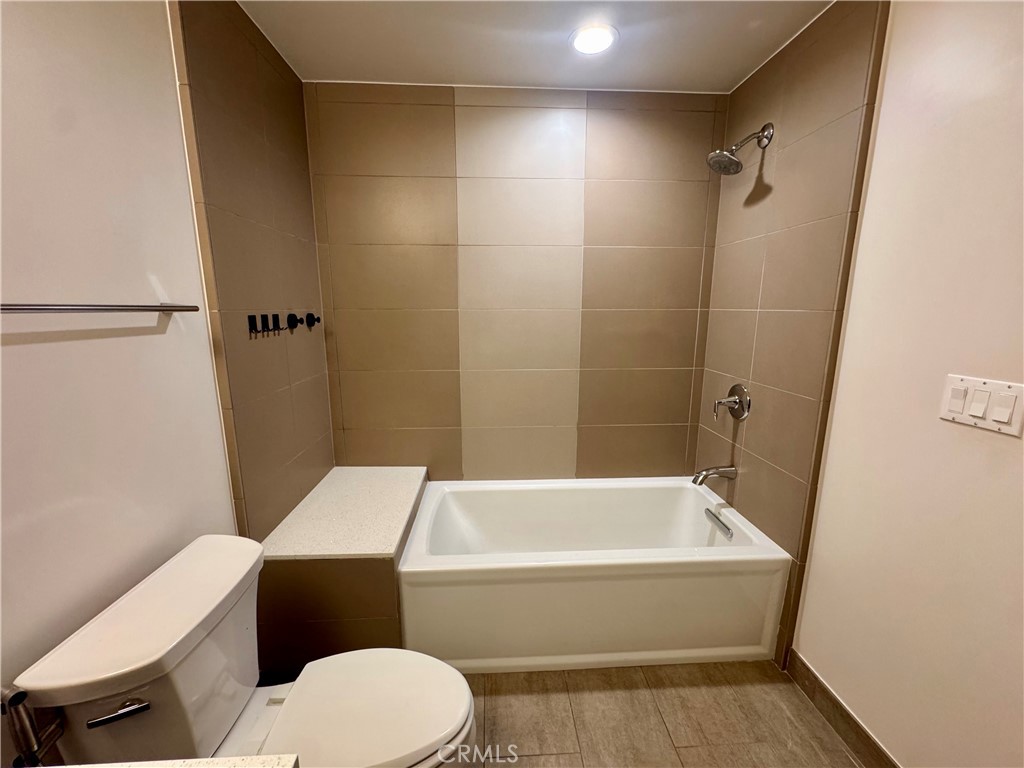 2428 East Del Mar Boulevard, Unit 101 Pasadena, CA 91107 - Photo 13 of 19 a bathroom with a toilet and a bath tub