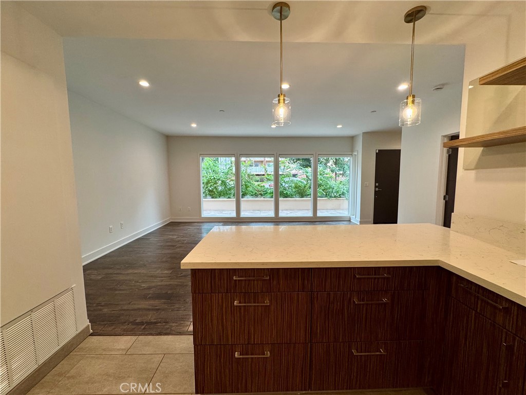 2428 East Del Mar Boulevard, Unit 101 Pasadena, CA 91107 - Photo 9 of 19 a spacious bathroom with a granite countertop sink a mirror and a bathtub