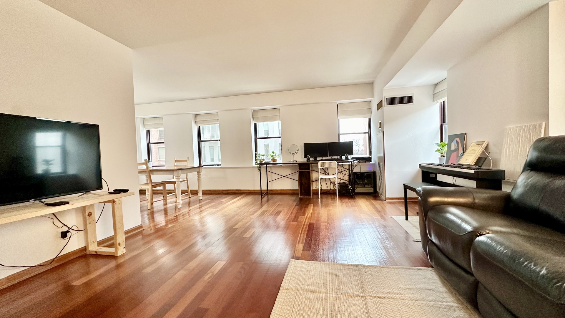 40 East 9th Street, Unit 402 Chicago, IL 60605 - Photo 8 of 24 a living room with furniture and a flat screen tv