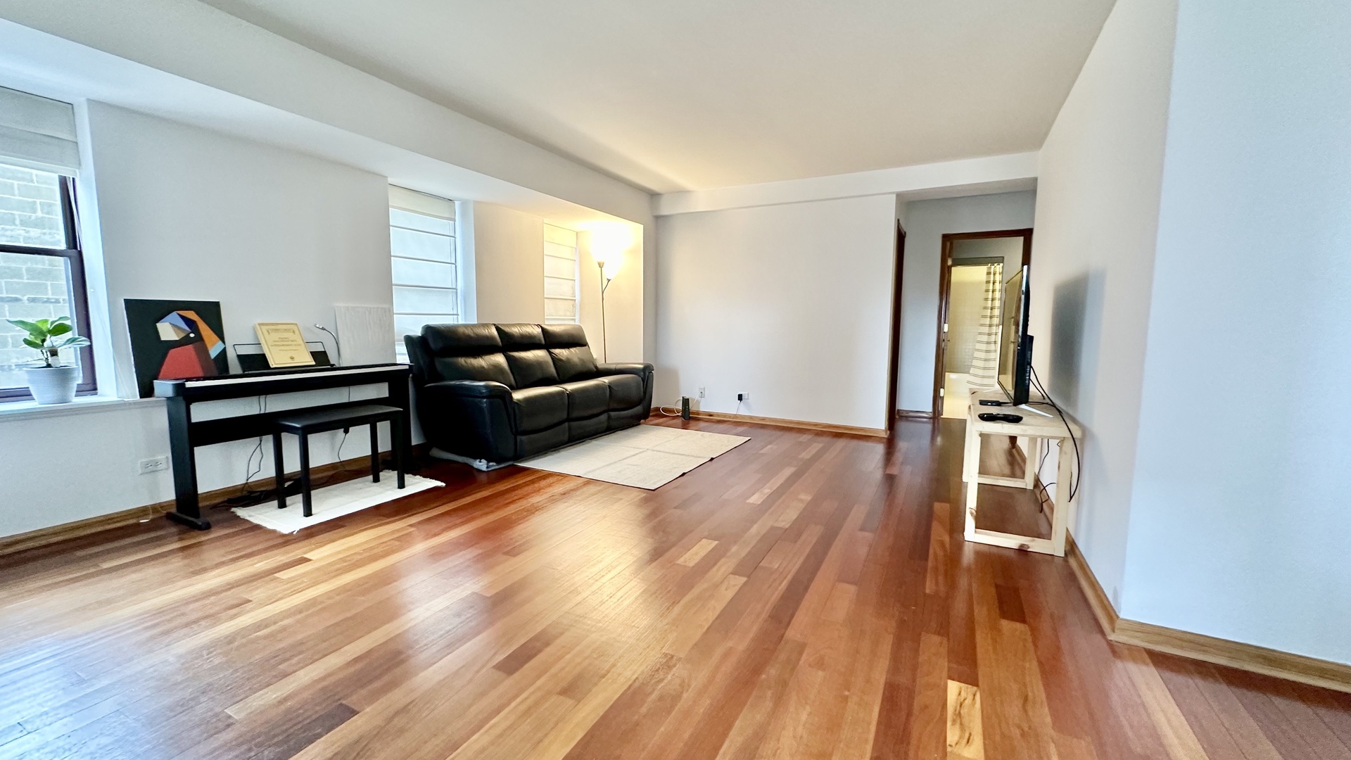 40 East 9th Street, Unit 402 Chicago, IL 60605 - Photo 9 of 24 a living room with furniture and a wooden floor