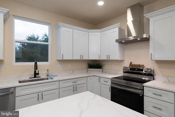 a kitchen with a sink a stove and cabinets