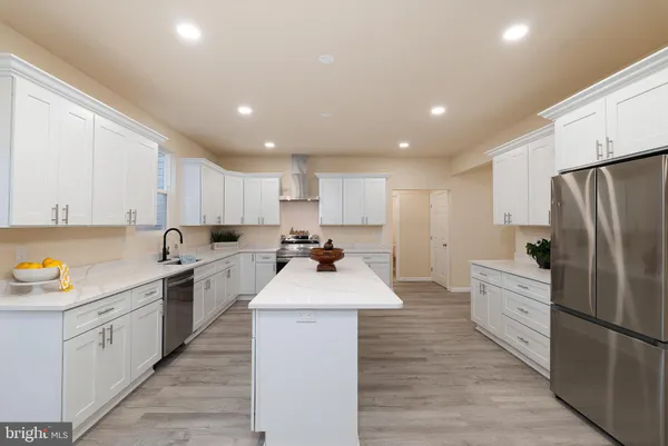 a kitchen with a sink and a mirror