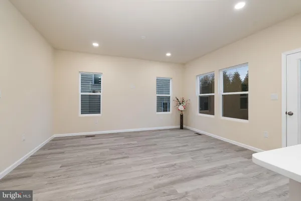 a spacious bedroom with a bed and a large window