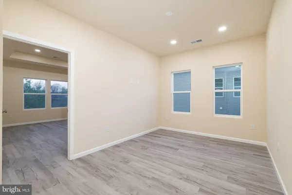 a view of an empty room with wooden floor