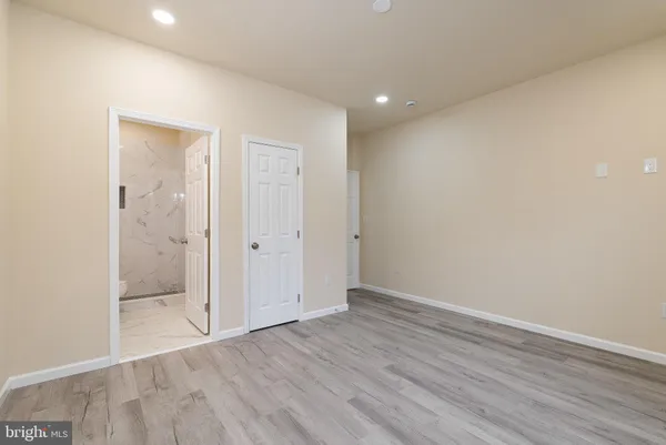 a bathroom with a sink toilet vanity and shower