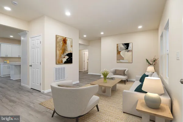 a view of a hallway with wooden floor and a bathroom