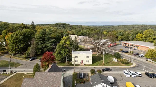 a view of a house with a yard patio and fire pit