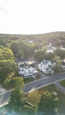 a view of a house with a yard and sitting area
