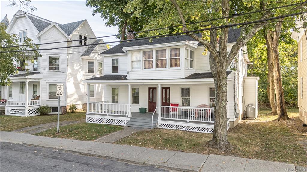 20 Church Street Claverack, NY 12534 - Photo 7 of 28 a view of a white house with large windows and a small yard