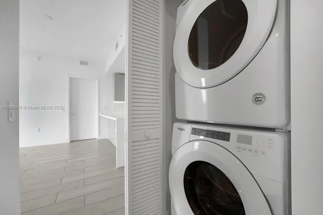 a close view of a utility room with dryer and washer