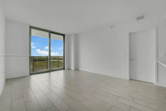 a view of an empty room with glass door